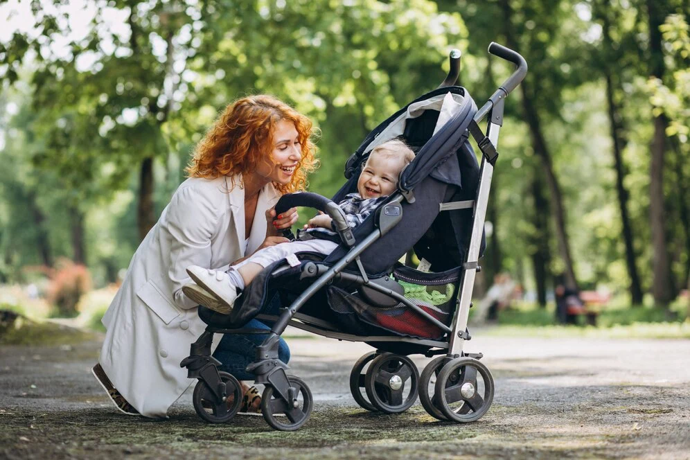 mother with her little son baby carriage