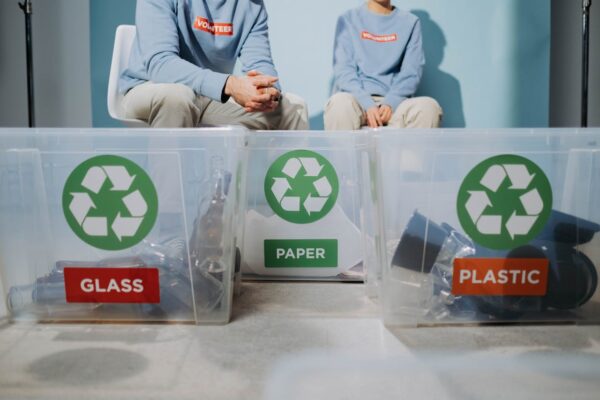 what-to-do-with-old-baby-stroller-and-car-seat-4 Volunteers sitting behind labelled recycling bins – eco-friendly recycling options for baby gear in Malaysia