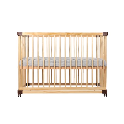 new-parents-tips-for-new-mums-dads-4 Light oak Koopers Nova Baby Cot front view on brown swivel wheels, featuring sturdy European hardwood frame, breathable mesh sides for airflow, fitted grey mattress, 9 adjustable height positions convertible to co-sleeper/playpen/toddler table – EN716 certified multifunctional design (0-3+ years) perfect for Malaysian nurseries and humid climate.